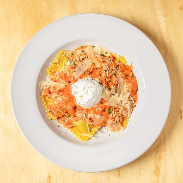 Granchio's ravioli with red sauce, topped with a dollop of ricotta cheese and parmesan.